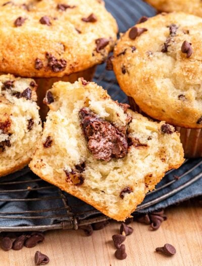 Half of a baked nutella chocolate chip muffin on blue dish towel.