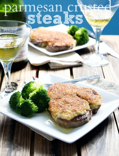 Two Plates on a table with Parmesan Crusted Steak and a side of broccoli