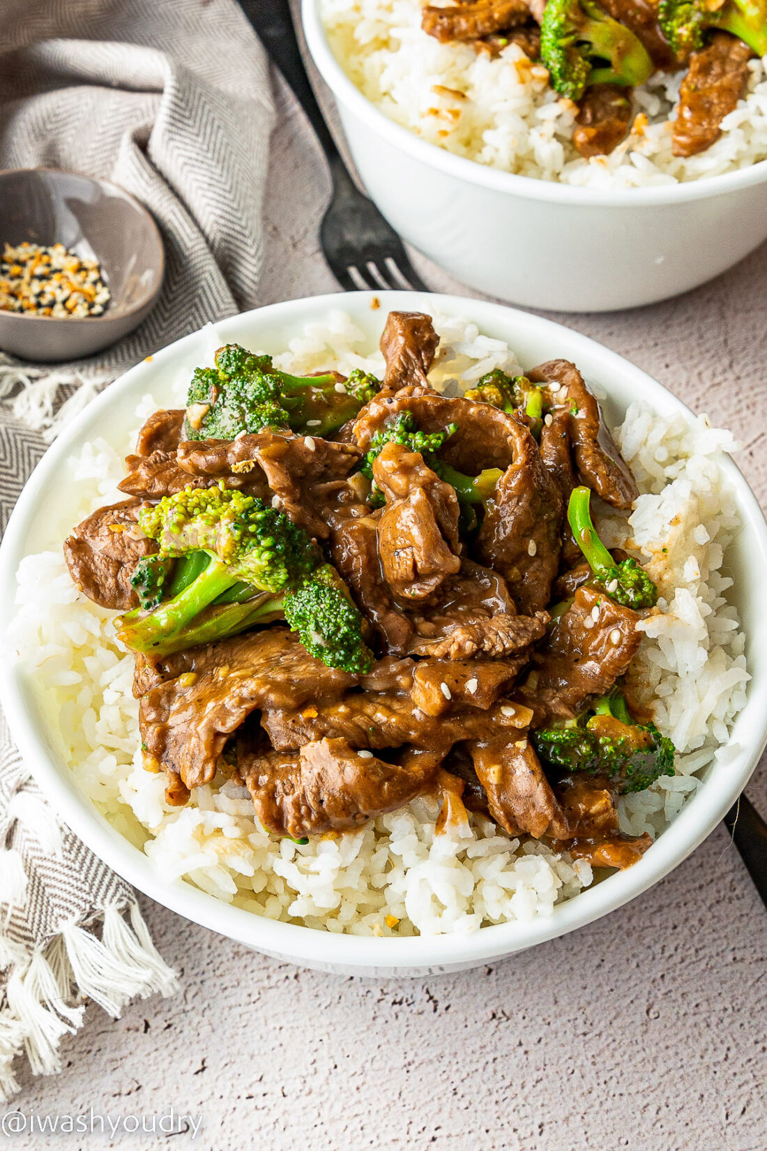 white bowl with rice and beef and broccoli sauce