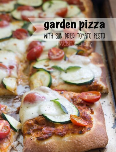 Pizza on a pan titled, "Garden Pizza with Sun Dried Tomato Pesto"