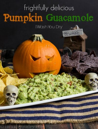 Frightfully Delicious Pumpkin Guacamole! Such a fun way to serve the guacamole for Halloween!