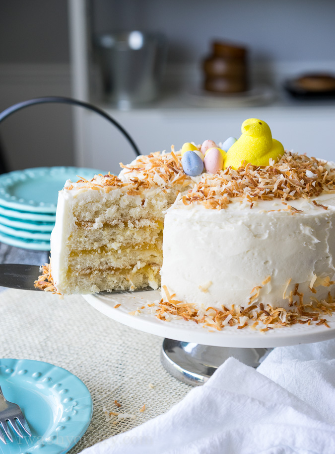 pulling out cake slice with spatula and toasted coconut.