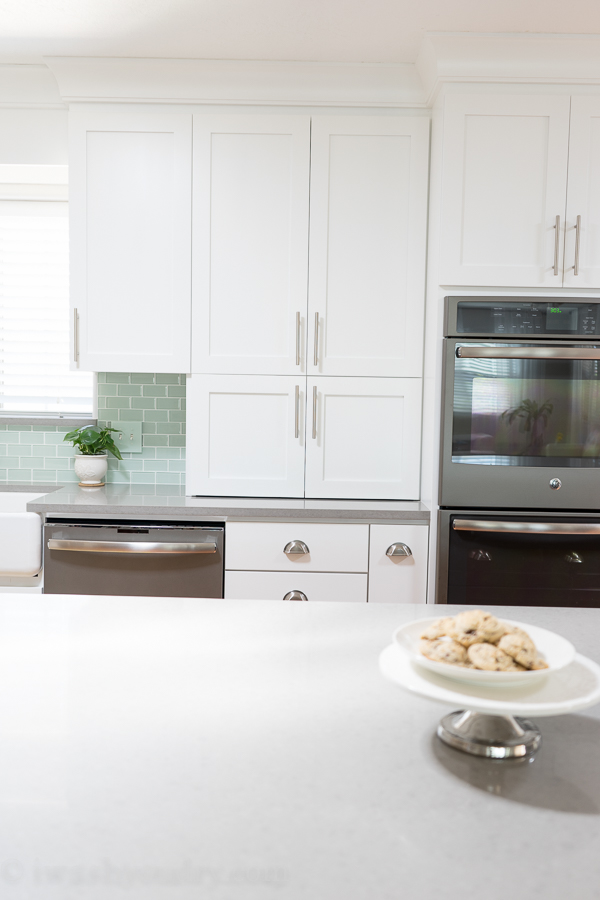 Kitchen Reveal - Love these white shaker-style cabinets with stainless steel cabinet pulls and satin nickel cup pulls. 