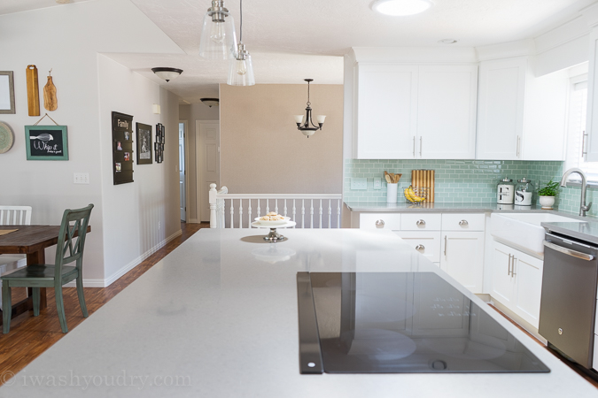 Love the bright white shaker style cabinets with the Quartz grey countertops. It looks like concrete, but much more durable and easy to take care of. 