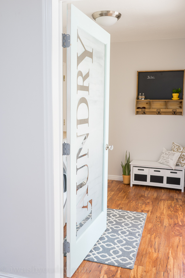 LOVE this Laundry Room door! She uses vinyl letters then frosted the glass for privacy, yet still lets in a lot of natural light. The rest of the kitchen reveal is just as awesome! 