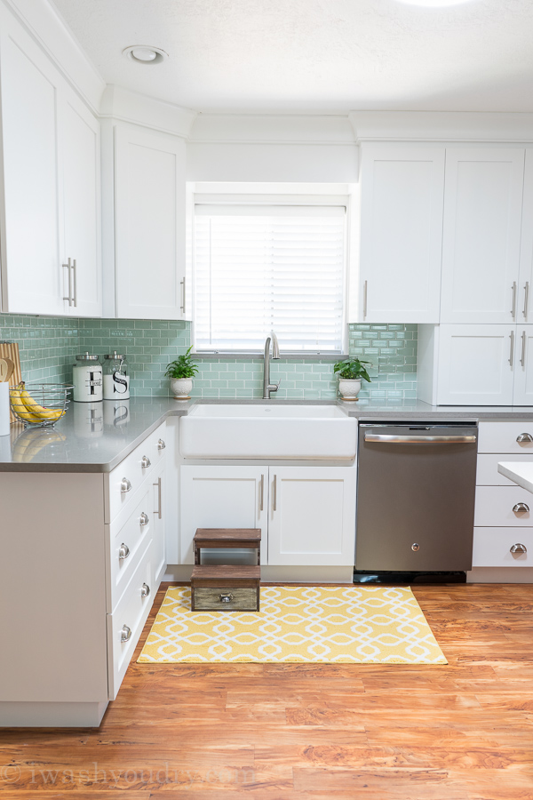 Gorgeous white cast-iron enameled, apron front, farm house sink by Kohler. Love the backsplash tile here as well. Stunning!