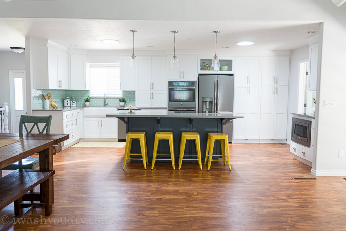 Such an amazing kitchen transformation! I'm loving the bright white cabinets with the grey Quartz countertops!