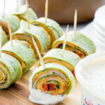 These Roasted Red Bell Pepper Hummus Pinwheels are full of so much flavor and are the perfect appetizer for any game day!