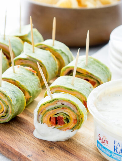 These Roasted Red Bell Pepper Hummus Pinwheels are full of so much flavor and are the perfect appetizer for any game day!