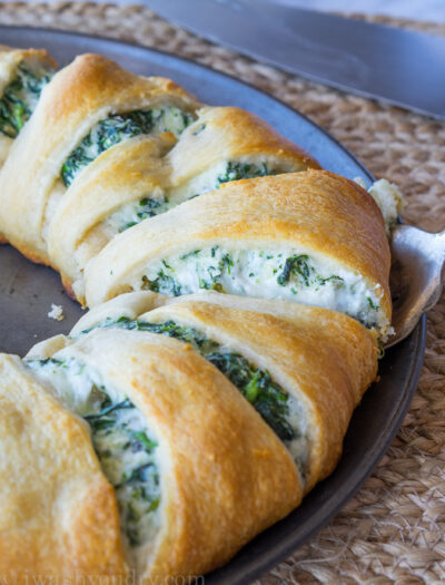 This Cheesy Spinach Jalapeño Crescent Ring is loaded with cream cheese, monterey jack cheese, spinach and diced pickled jalapeños. It's so easy to make and EVERYONE loves it!