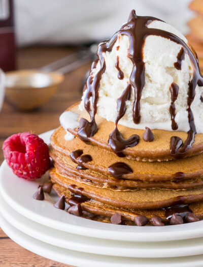 These Chocolate Pancakes are just a few simple ingredients and are made extra special with a scoop of vanilla ice cream and drizzle of chocolate syrup!