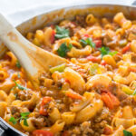 This Cheesy Sausage and Macaroni Skillet dinner recipe is super quick and easy, perfect for busy weeknights!