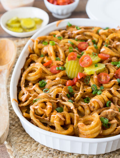 This Cheeseburger and French Fry Casserole is filled with all the hamburger favorites and even topped with crispy seasoned french fries and a creamy fry sauce!