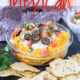 This is by far the easiest way to have your #unofficialmeal. This easy Mexican Layered Hummus Dip starts with a tub of Sabra hummus and is piled high with all the classic taco fillings! So good!