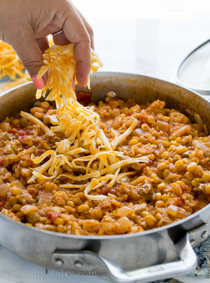 This one pan, Mexican Chicken Taco Skillet is filled with chicken, rice and corn, then topped with all the yummy taco fixin's for a delicious dinner recipe that my family requests over and over again!