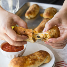 These super simple Cheesy Taco Sticks are buttery breadsticks filled with taco meat and lots of cheese! Perfect for snacking or watching the big game!