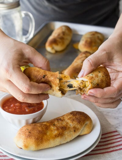 These super simple Cheesy Taco Sticks are buttery breadsticks filled with taco meat and lots of cheese! Perfect for snacking or watching the big game!