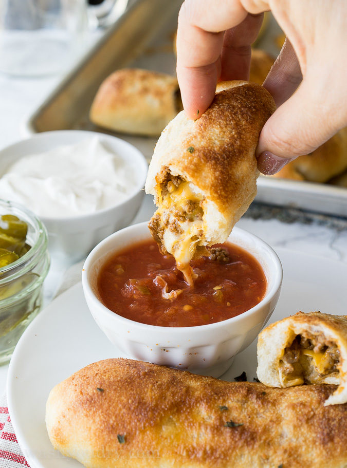 These super simple Cheesy Taco Sticks are buttery breadsticks filled with taco meat and lots of cheese! Perfect for snacking or watching the big game!