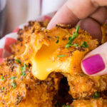 OMG! These Crispy Queso Bites are coated in nacho cheese doritos and then fried to gooey cheesy perfection!