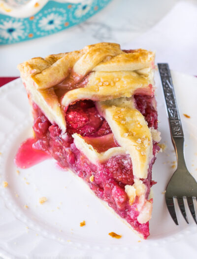 This homemade Raspberry Pie recipe is perfection! The filling is sweet and stays together, doesn't fall apart!