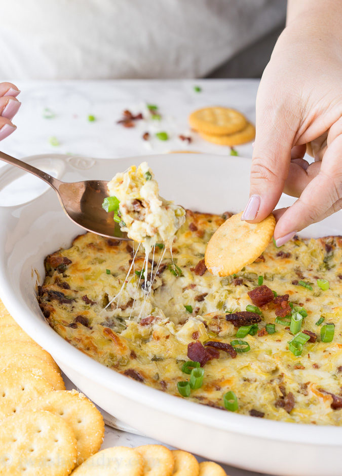 This Cheesy Bacon Artichoke Dip is just 5 ingredients and so easy to make! There are never any leftovers!