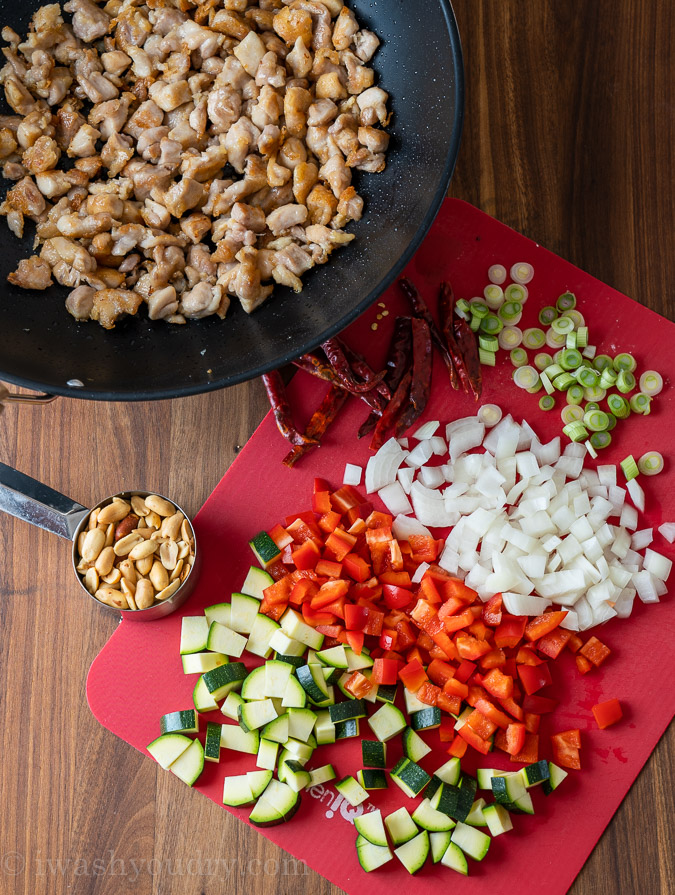 ingredients for kung pao chicken and veggies on cutting board