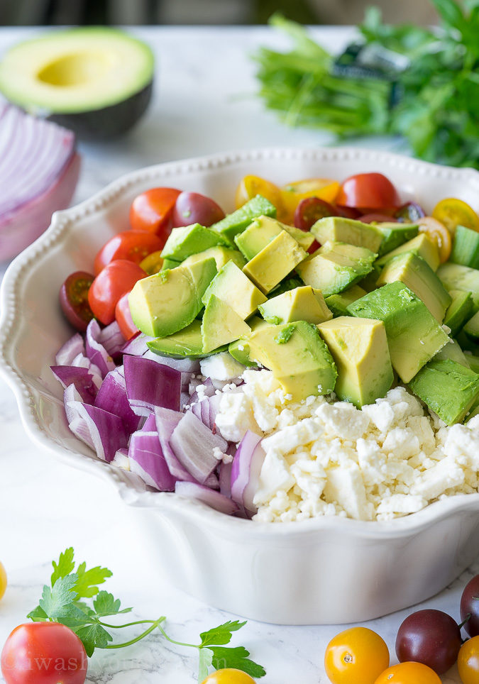 This Cucumber Tomato Avocado Salad is so fresh and delicious! I love the super simple dressing that it's tossed in!