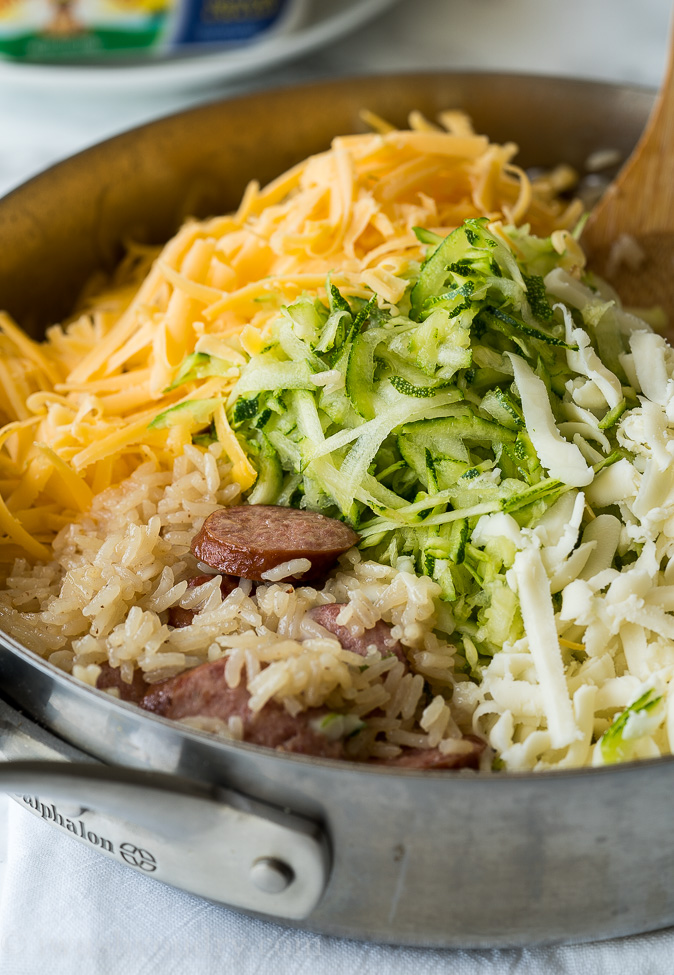 This Cheesy Sausage Zucchini Rice Skillet is a super quick dinner that's filled with everything my family loves, plus I get to sneak in some veggies!