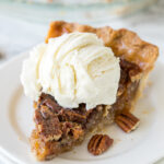 slice of pecan pie with ice cream on top.