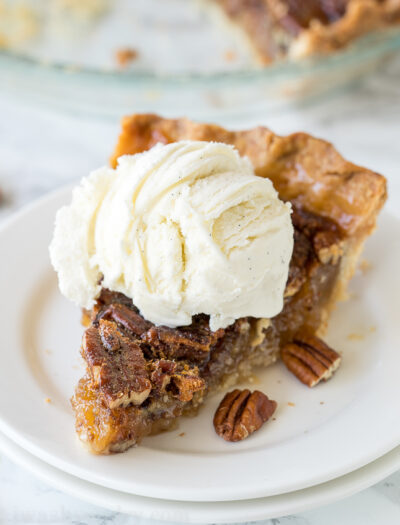 slice of pecan pie with ice cream on top.