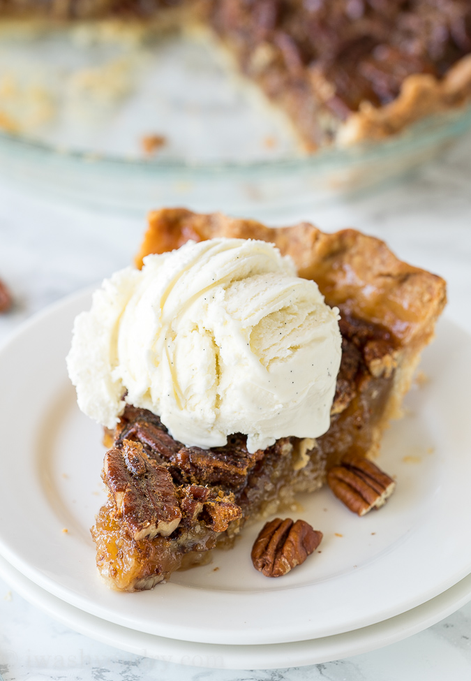 slice of pecan pie with ice cream on top.