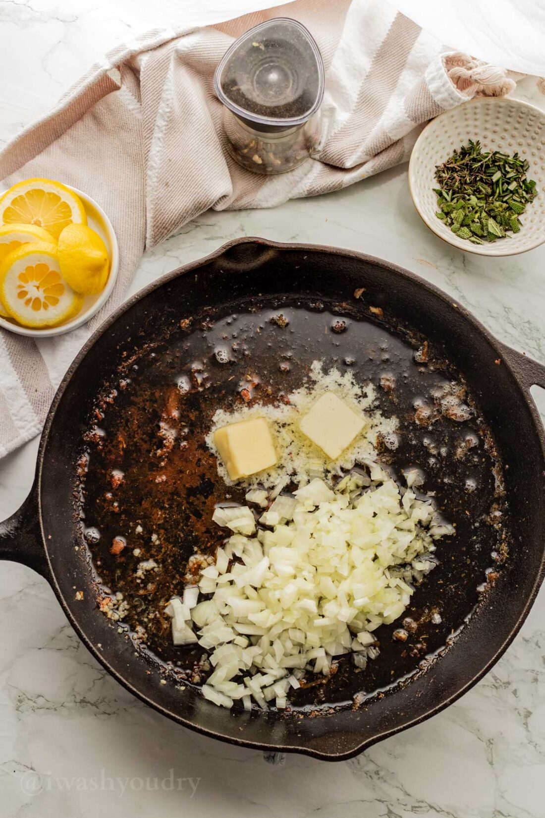 Butter and onion in black skillet.