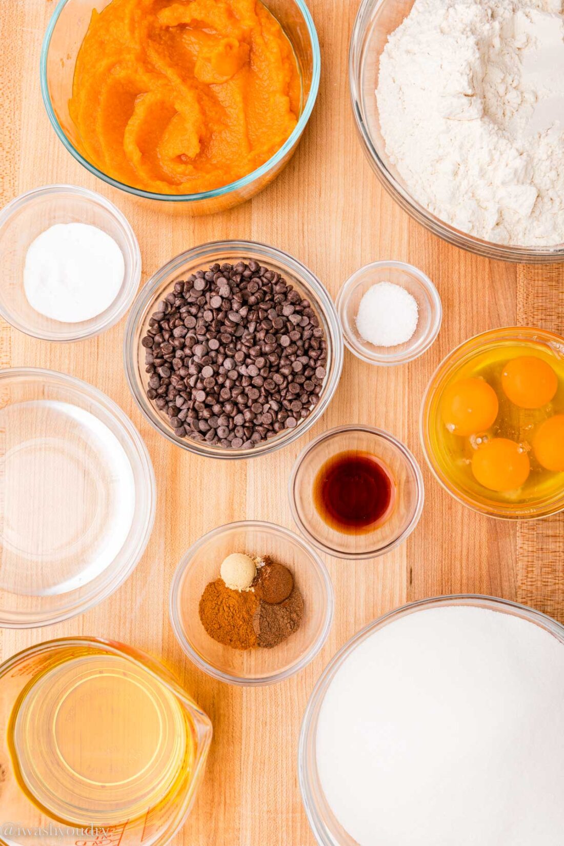 ingredients for pumpkin chocolate chip loaf on wood board. 