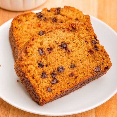 Slices of Pumpkin Chocolate Chip loaf on white plate.