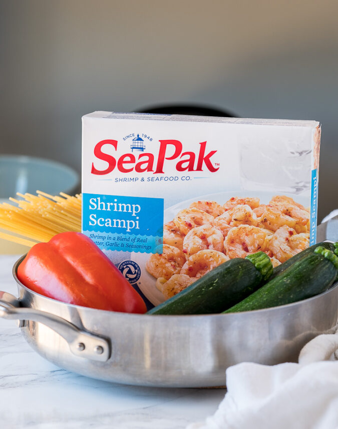 All you need to make this easy seafood dinner recipe is a box of frozen shrimp scampi from SeaPak, some zucchini, bell pepper and pasta!