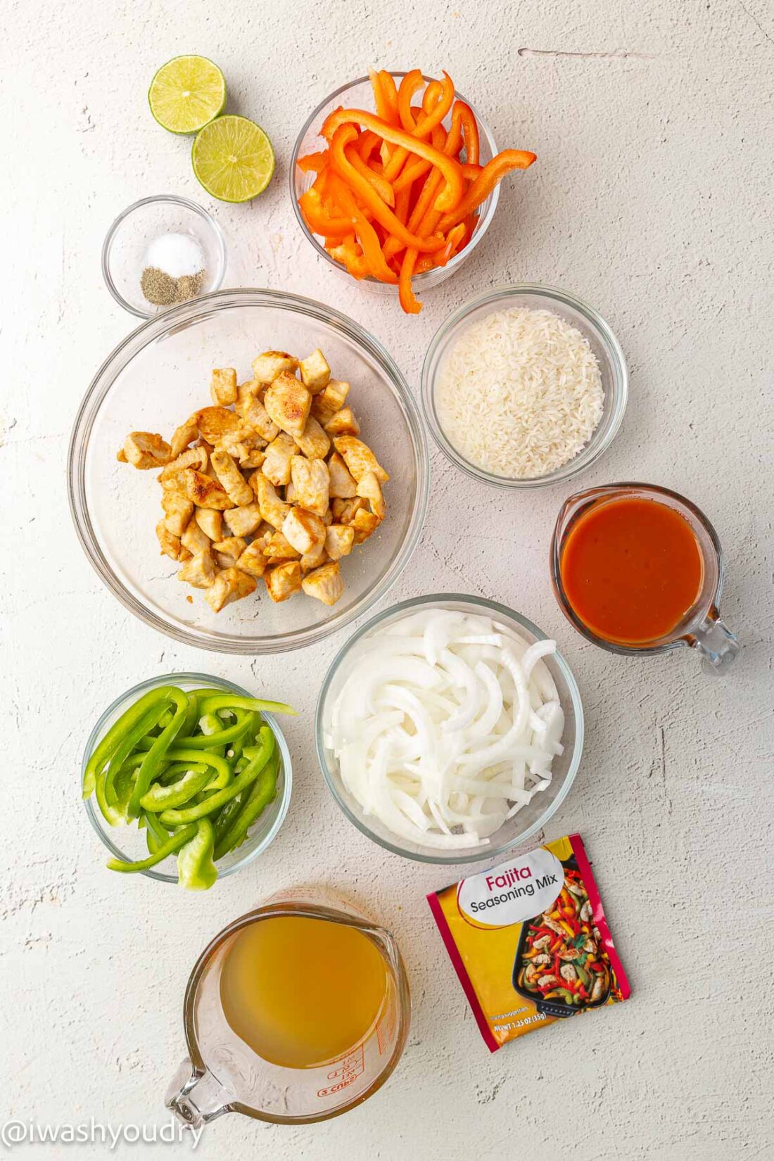 ingredients for chicken fajitas with rice on white surface.