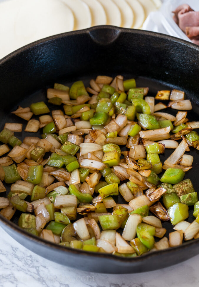 Sauté the diced peppers and onions in a little bit of butter until they're soft and tender.