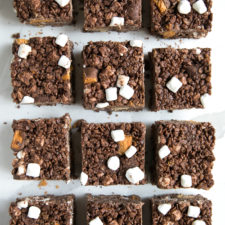 Food on a table, with squares of chocolate Rice Krispie treats