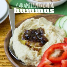 A close up of caramelized onion hummus on a veggie plate