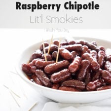 A bowl of mini smoked sausages on a table, with a few with toothpicks in them