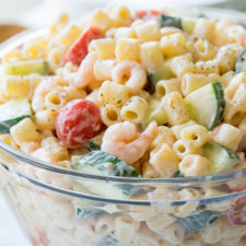 A bowl of food of pasta salad with shrimp