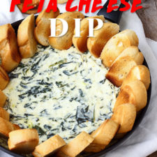 A tray of food, with spinach cheese dip in the middle surrounded by bread slices