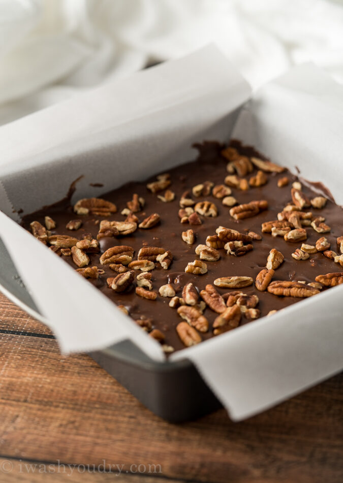 Pour the chocolate fudge into a parchment lined baking pan and pop in the fridge to set.