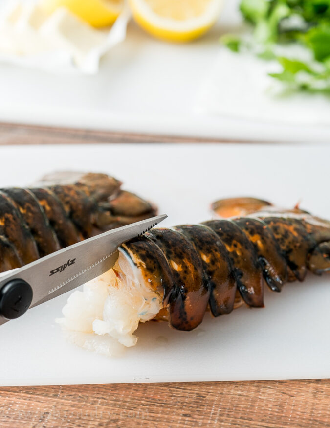 First thing you're going to want to do is use some sharp kitchen scissors to cut down the middle of the lobster shell, just until you get to the fins.