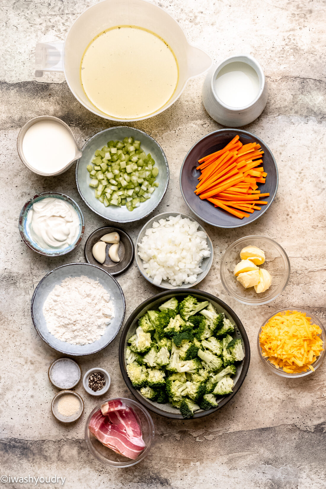 ingredients for broccoli soup with cheese on light colored surface.