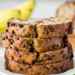 A piece of chocolate cake on a plate, with Banana and Bread