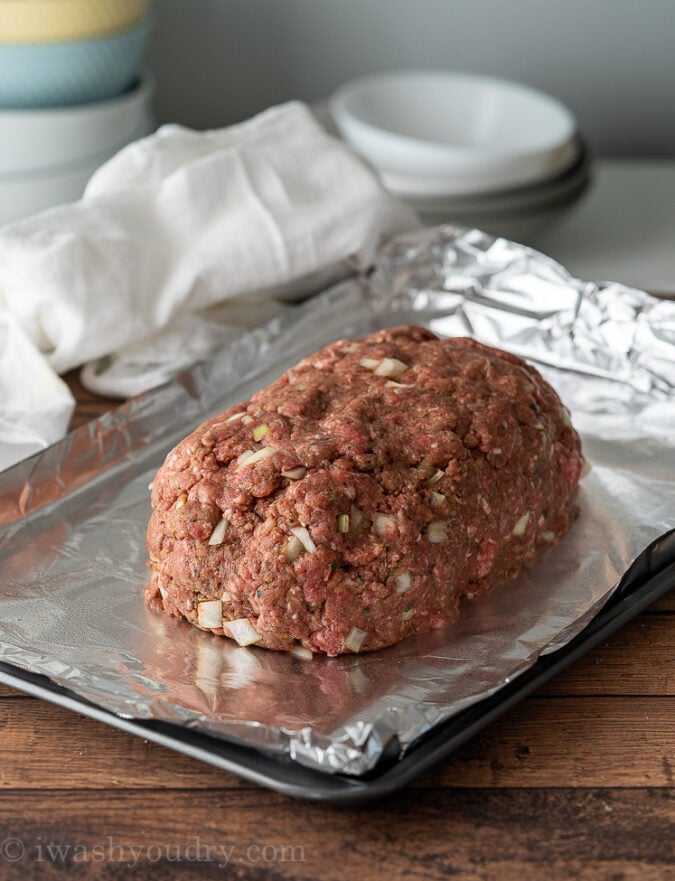 Free form meatloaf recipe on baking sheet ready for oven.