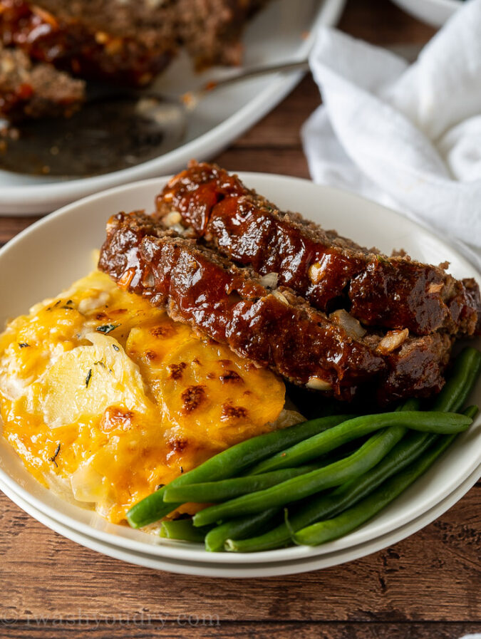 glazed meatloaf on top of scalloped potatoes