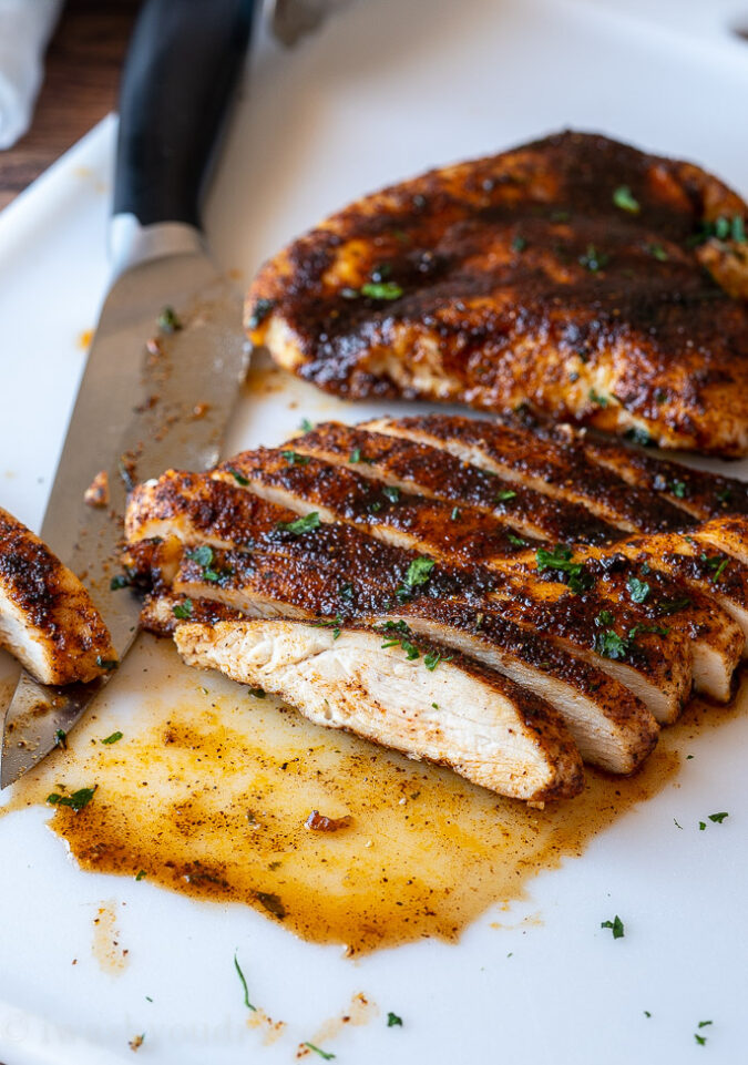 sliced chicken breast on white cutting board