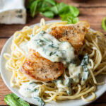 My family really LOVES this super easy chicken recipe! Creamy Garlic Parmesan Chicken with wilted spinach! YUM!